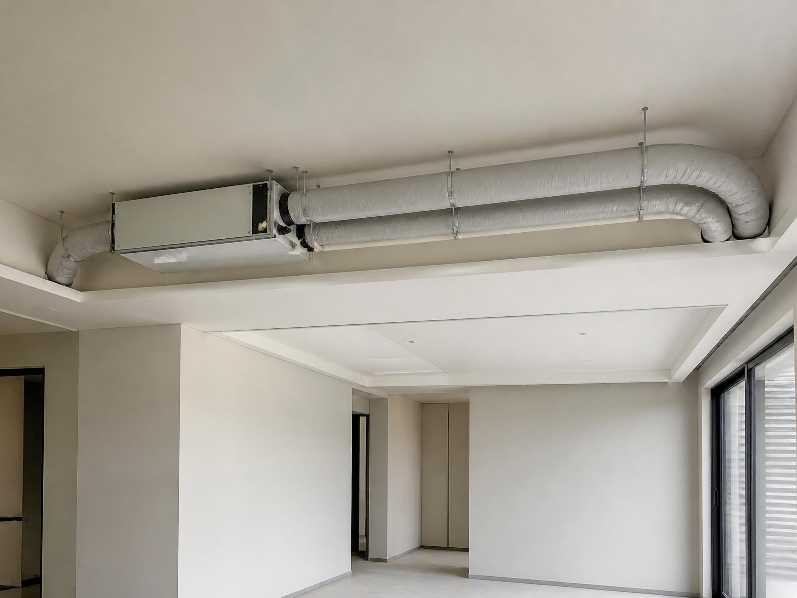 A single concealed ONYX Core unit installed above a false ceiling with its own dedicated return and supply ducts, neatly routed and supported, with a service access panel below.